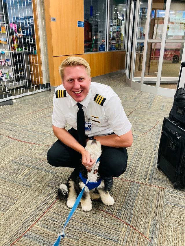 A delta pilot petting Emmet